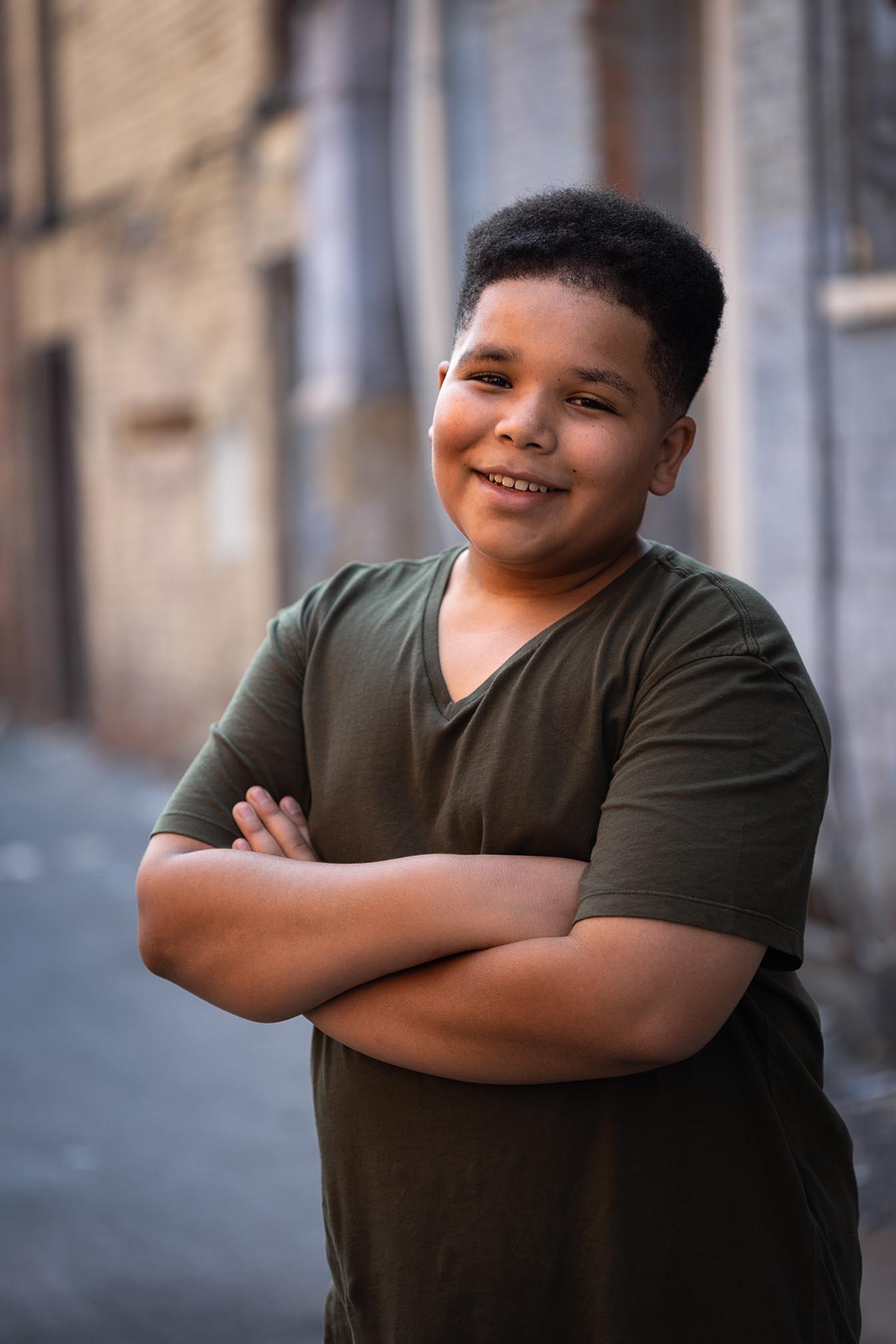 pre-teen poses in a city alley