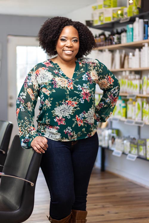 an entrepreneur poses in her salon